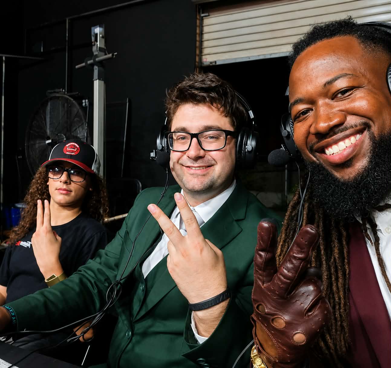 Trystan in a commentary booth with two fellow commentators