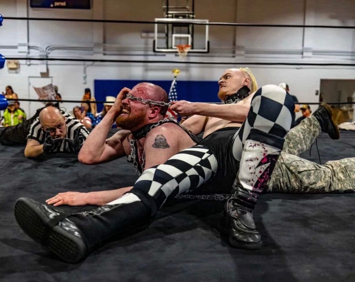 Referee Rodney Hunter counting a pinfall during a live independent wrestling match