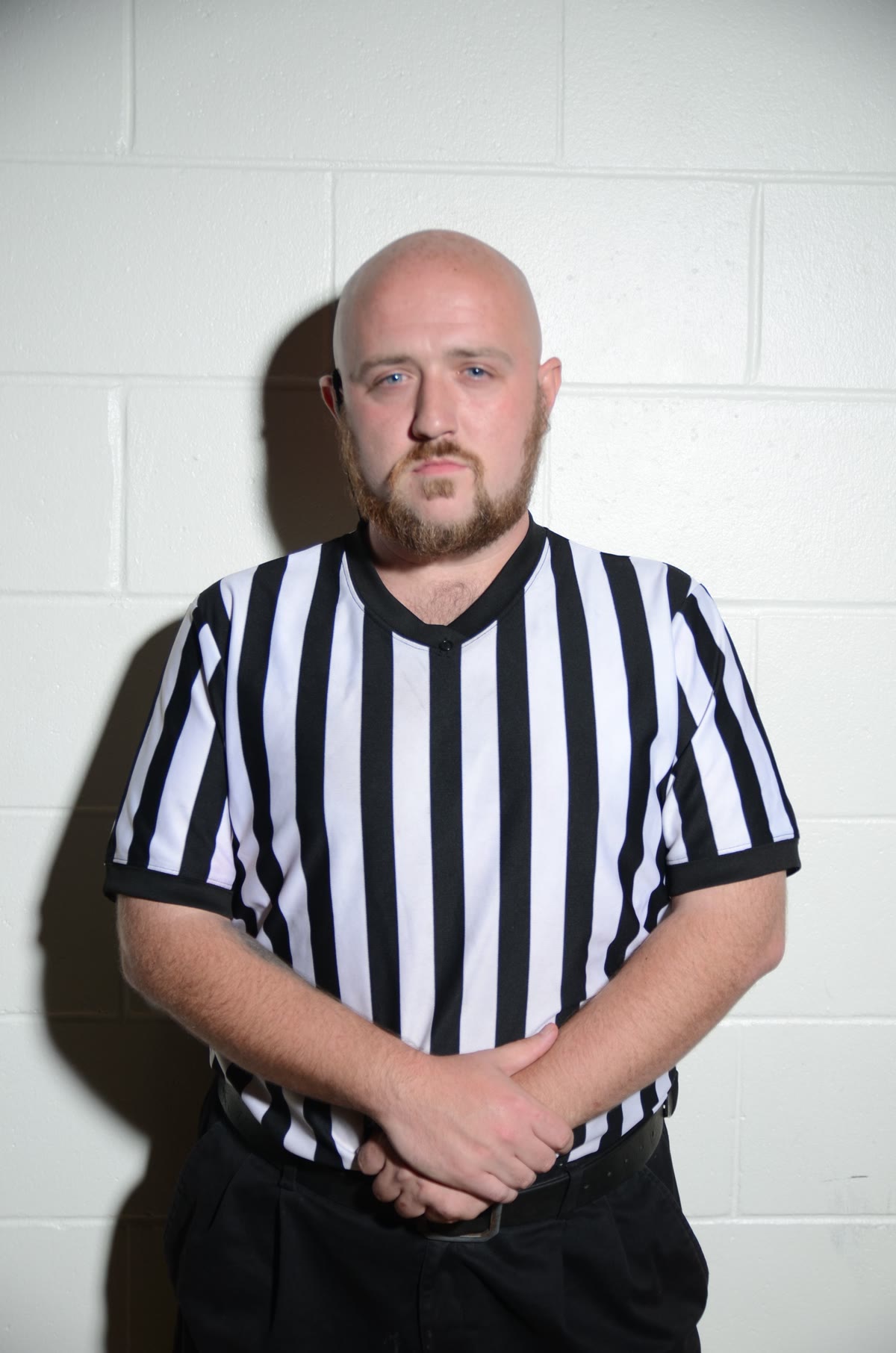Referee Rodney Hunter posing in his black-and-white striped referee shirt