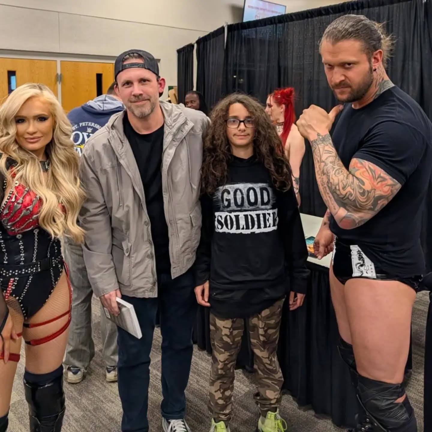 Trystan with Killer Kross and Scarlett at a wrestling event
