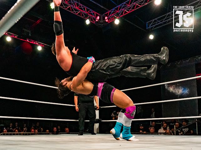 Jimmy House lifting an opponent overhead for a suplex in the ring