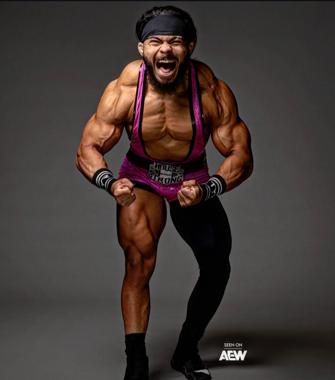 Jimmy House flexing and yelling in pink House Strong wrestling gear
