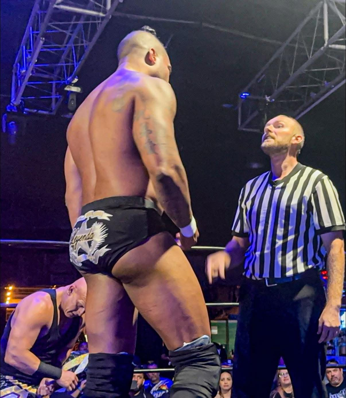 Richard White officiating a professional wrestling match in a striped referee shirt