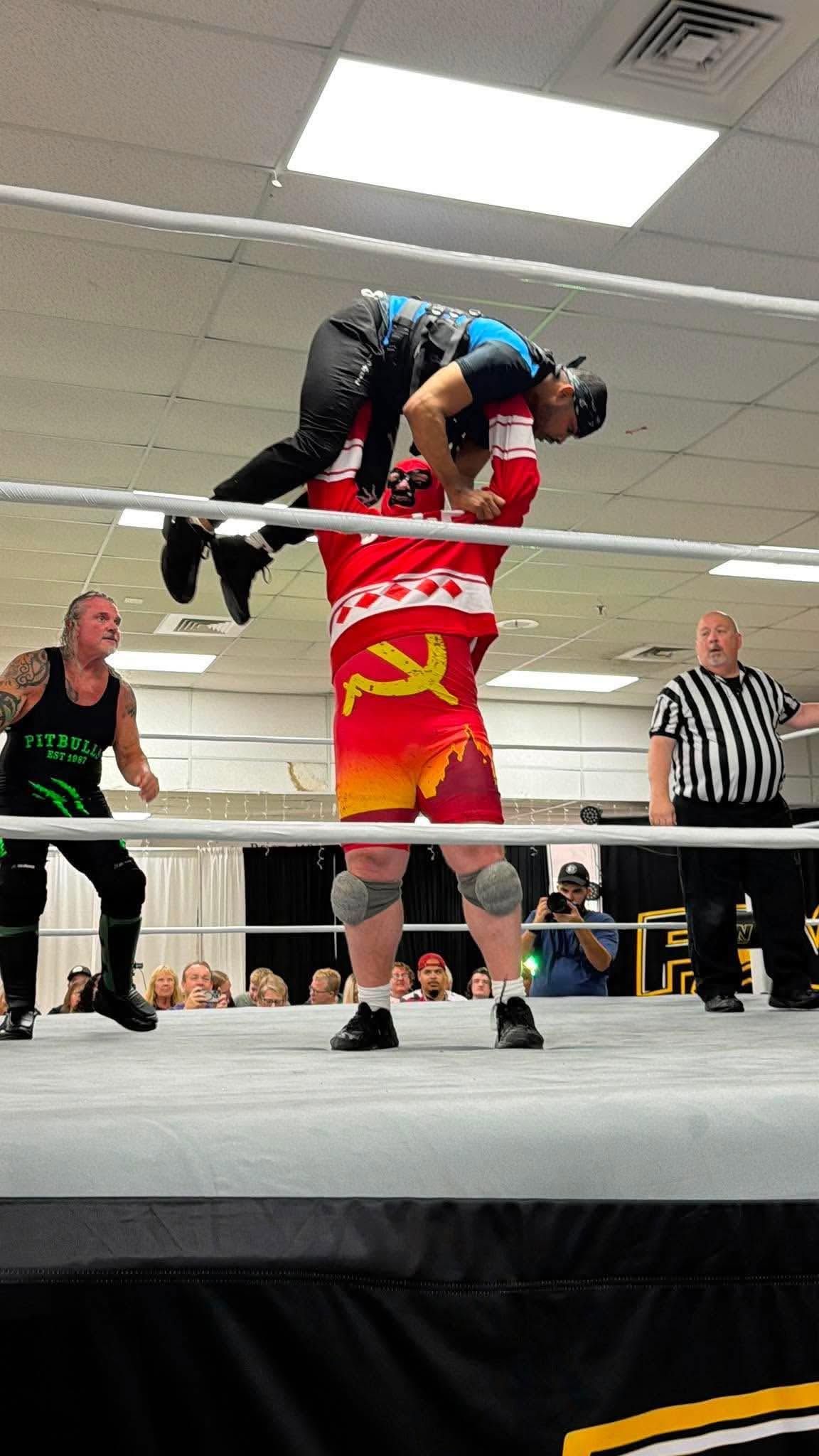 Russian Manimal Volkoff pressing Jason Dugan overhead in the ring